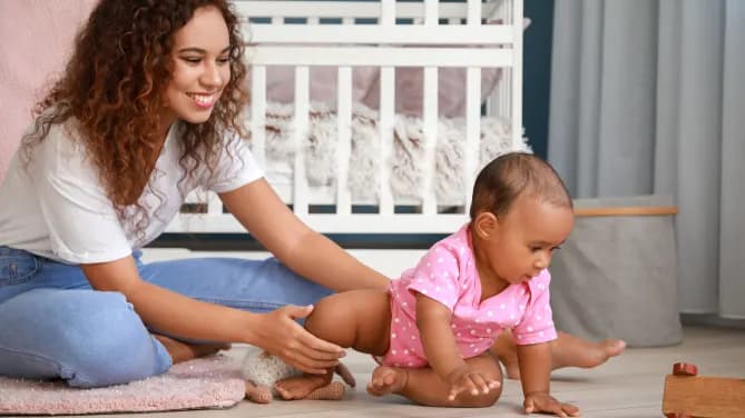woman playing with a baby