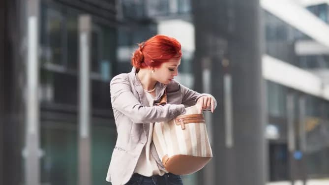 woman looking for something in her bag