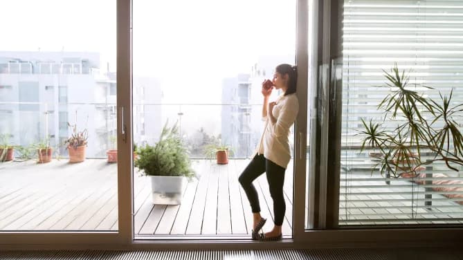 tranquil woman drinking coffee on patio